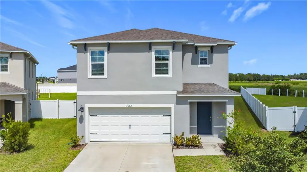 Front exterior of a new home in Harmony West, St. Cloud, FL, highlighting curb appeal (Image 1).