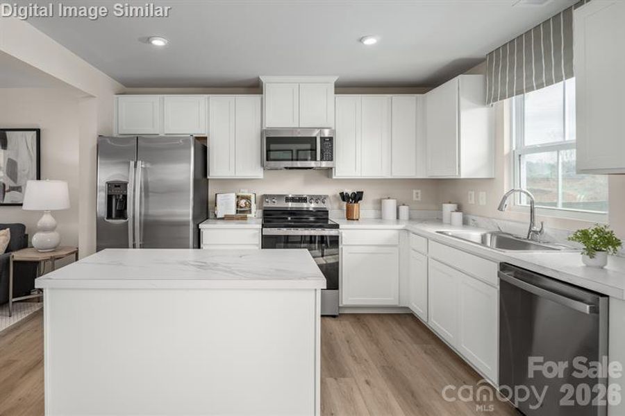 Enjoy the clean lines and generous storage of 36-inch cabinetry in this beautifully appointed kitchen