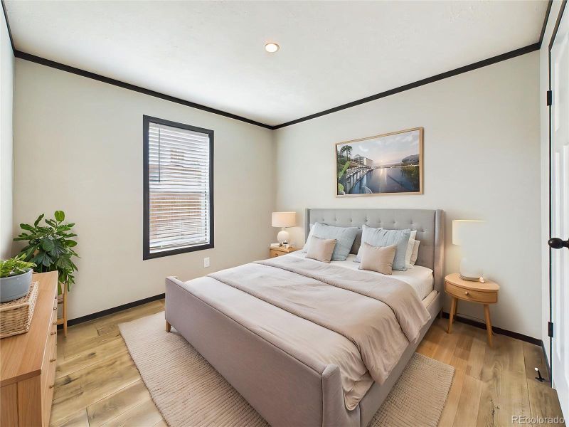 (Virtually Staged) – Comfortable bedroom 3 layout showcasing space for a full furniture set, highlighted by soft natural light and a clean design.