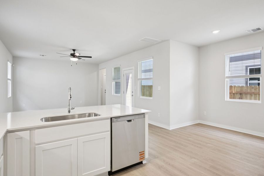 A kitchen with white cabinets.
