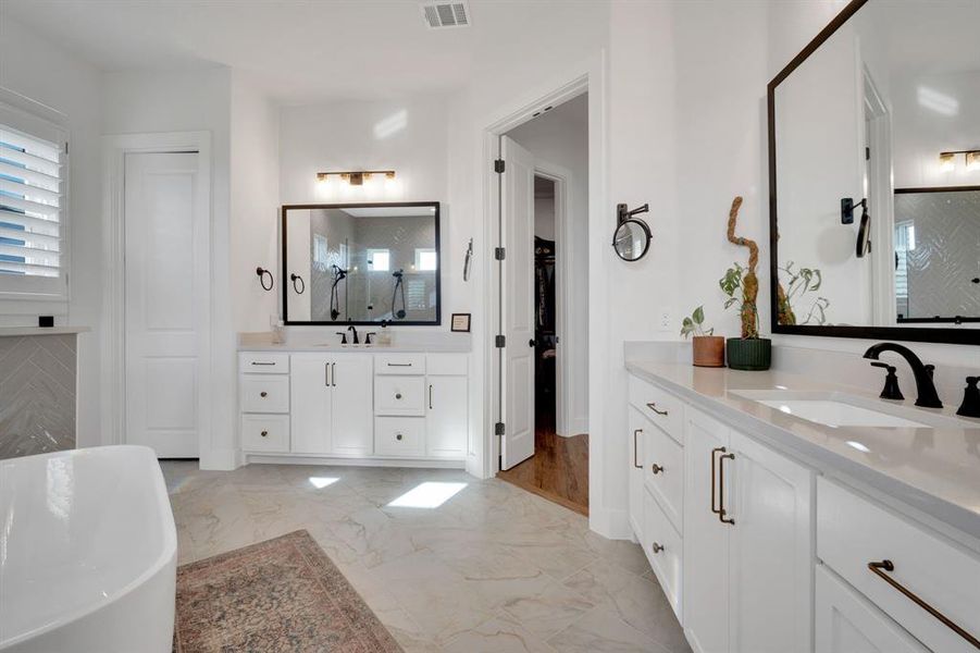 Double oversized vanities with designer mirrors and lighting!
