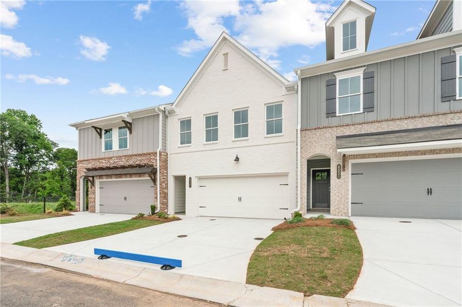 Front exterior of a new home in Wilkins Walk, Mableton, GA, highlighting curb appeal (Image 1). Front exterior of a new home in Wilkins Walk, Mableton, GA, highlighting curb appeal (Image 1).