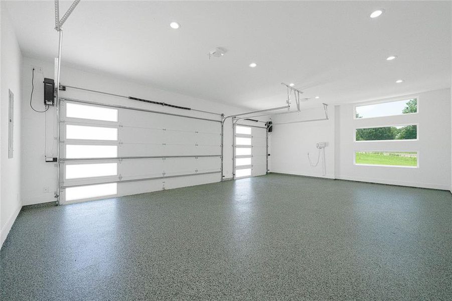 Garage featuring recessed lighting and baseboards Garage featuring recessed lighting and baseboards