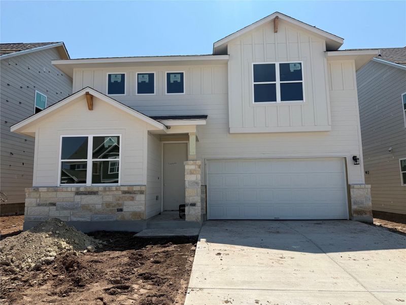 Front exterior of a new home in Cannon Ranch 45s, Dripping Springs, TX, highlighting curb appeal (Image 18). Front exterior of a new home in Cannon Ranch 45s, Dripping Springs, TX, highlighting curb appeal (Image 18).