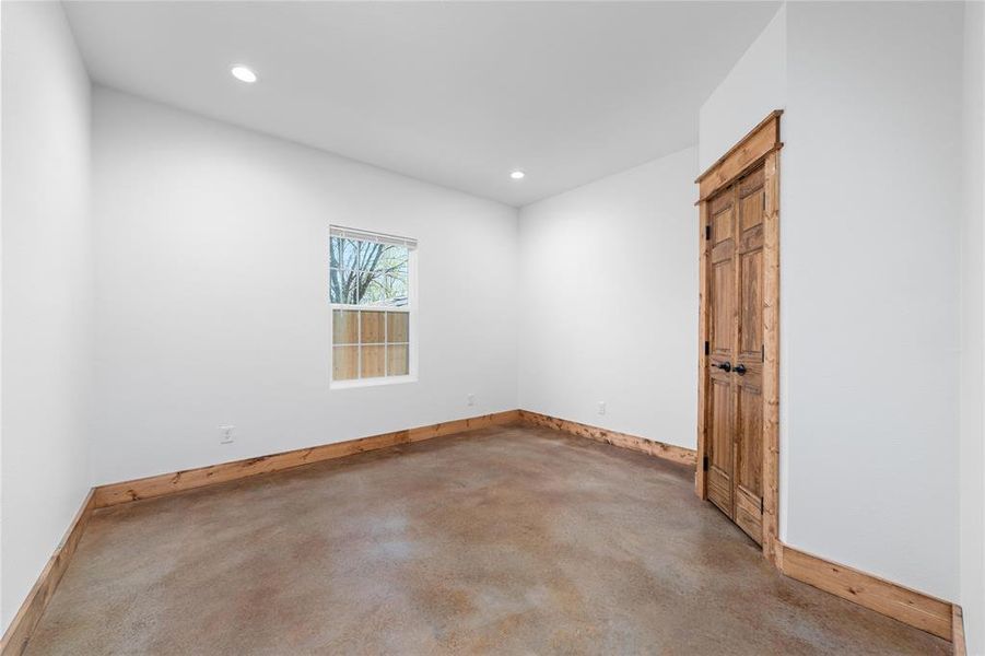 Unfurnished room with baseboards, recessed lighting, and concrete flooring Unfurnished room with baseboards, recessed lighting, and concrete flooring