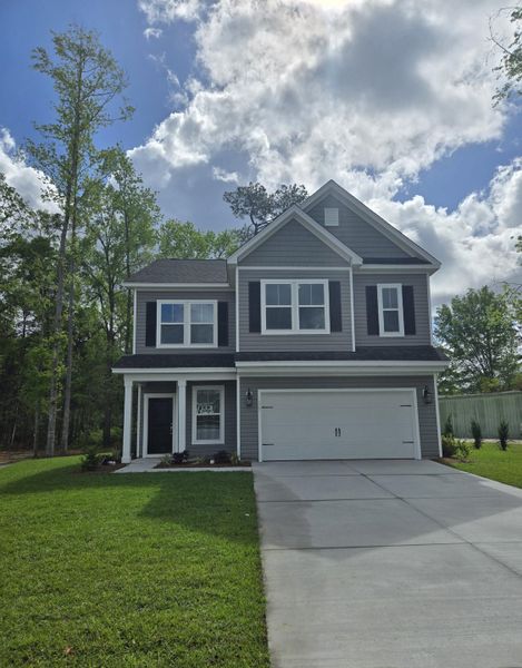Front exterior of a new home in Timothy Lakes, Ridgeville, SC, highlighting curb appeal (Image 2). Front exterior of a new home in Timothy Lakes, Ridgeville, SC, highlighting curb appeal (Image 2).