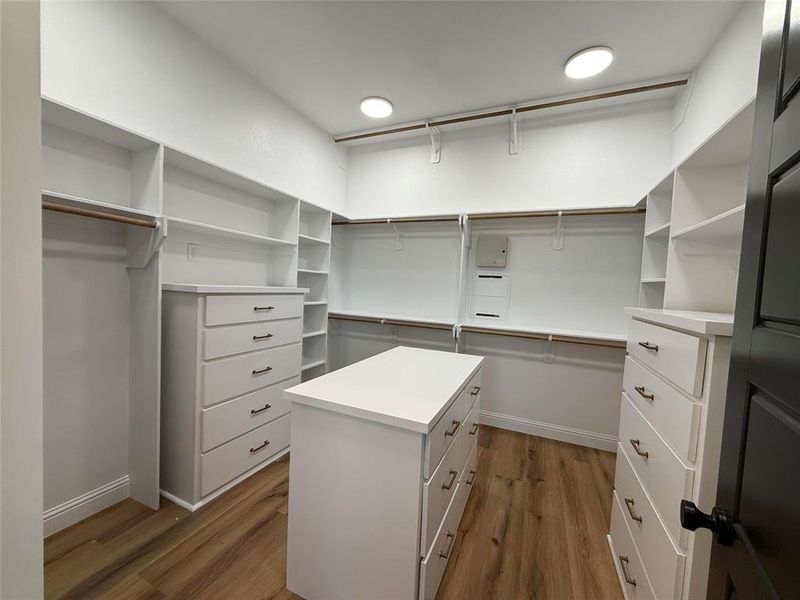 Spacious closet featuring light wood finished floors Spacious closet featuring light wood finished floors