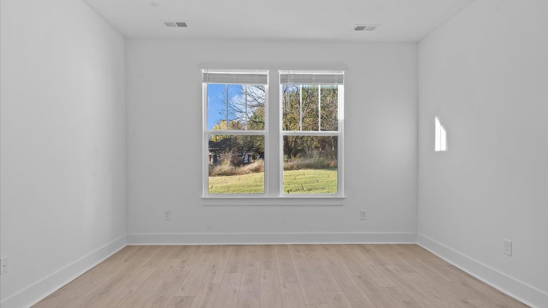 Eye-catching details and elegant finishes in the vibrant primary suite of this select home