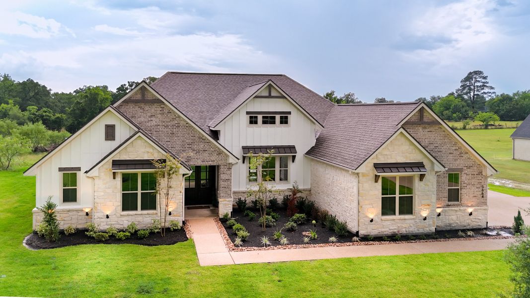 Front exterior of a new home in Windmill Hill, Bryan, TX, highlighting curb appeal (Image 27).