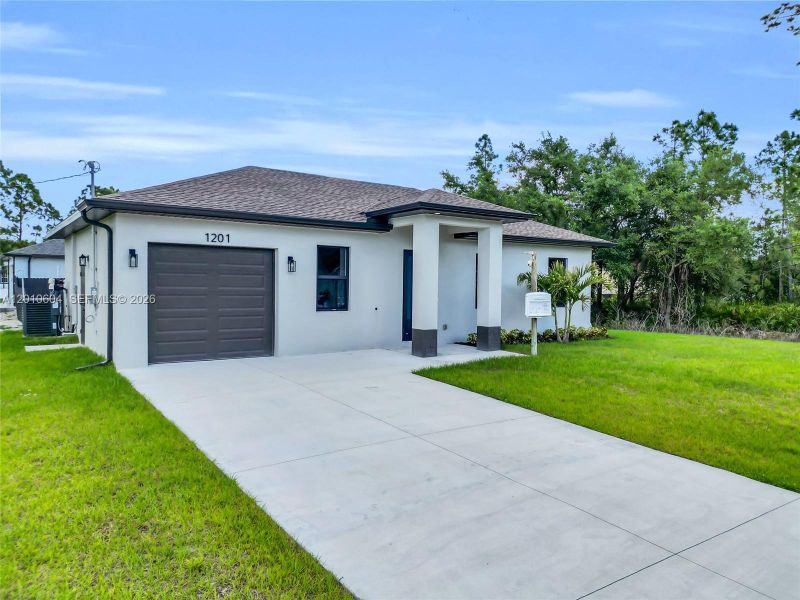 Front exterior of a new home in , Lehigh Acres, FL, highlighting curb appeal (Image 24).