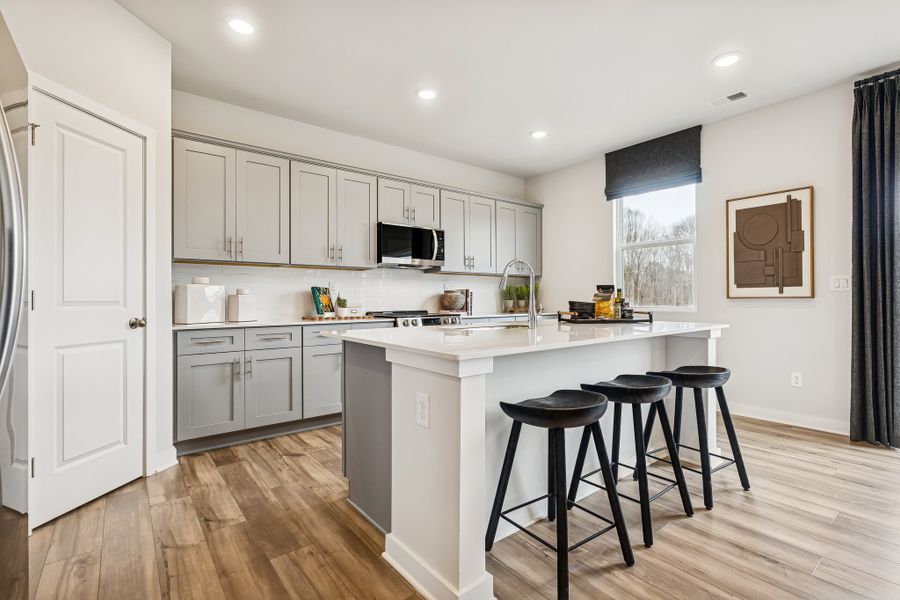 A kitchen with stools and a table. A kitchen with stools and a table.