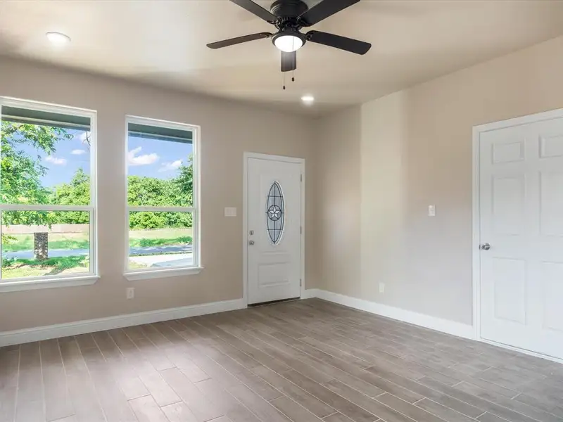 Entrance foyer featuring a ceiling fan and wood finished floors Entrance foyer featuring a ceiling fan and wood finished floors