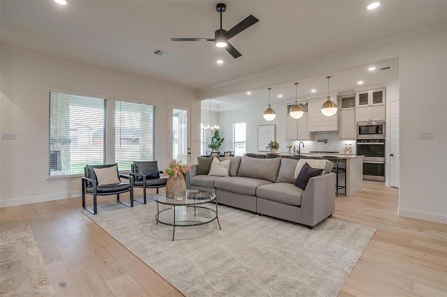 Living room with beautiful hardwood floors and 10 ft ceilings.