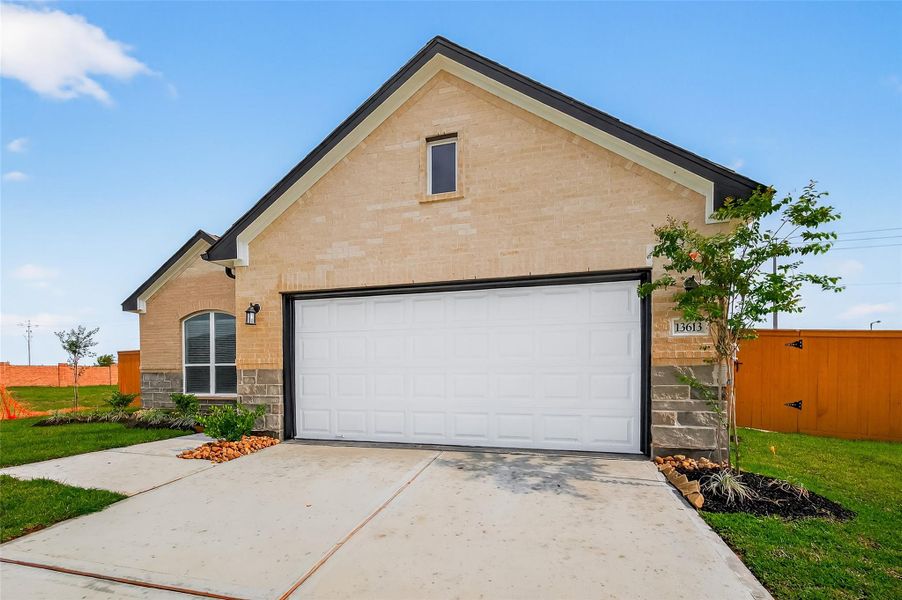 Front exterior of a new home in Lago Mar, La Marque, TX, highlighting curb appeal (Image 22).