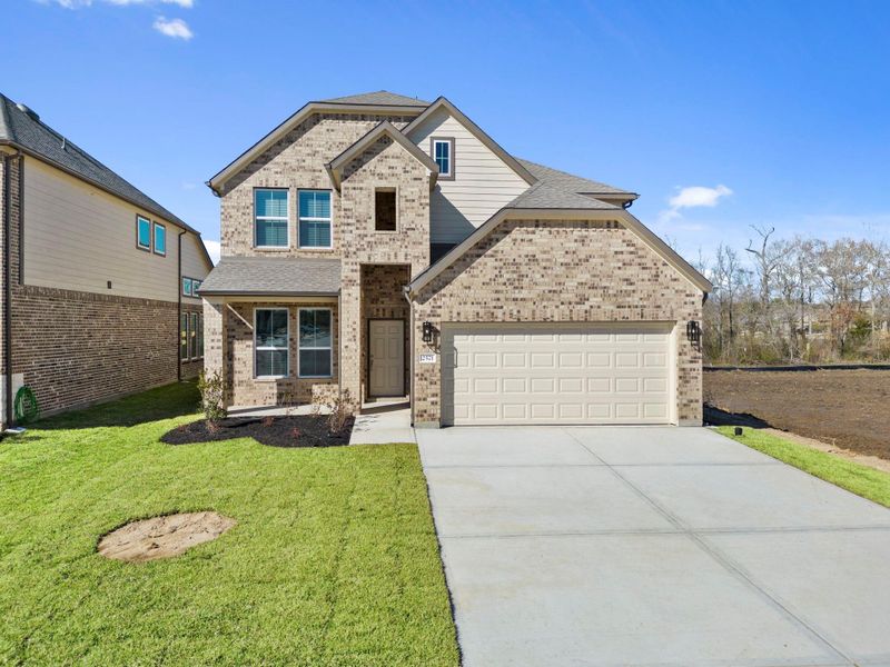 Front exterior of a new home in Barton Creek Ranch, Conroe, TX, highlighting curb appeal (Image 16).