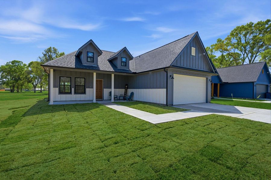 This charming home features a modern design accented by a classic gabled roof and eye-catching dormer windows. A spacious attached garage and inviting front porch make it perfect for both convenience and outdoor enjoyment. (photos of grass have been digitally enhanced for presentation.)
