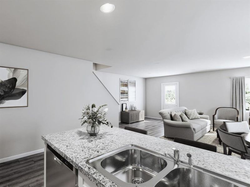 Kitchen with dark wood-style floors, baseboards, dishwasher, and a sink Kitchen with dark wood-style floors, baseboards, dishwasher, and a sink