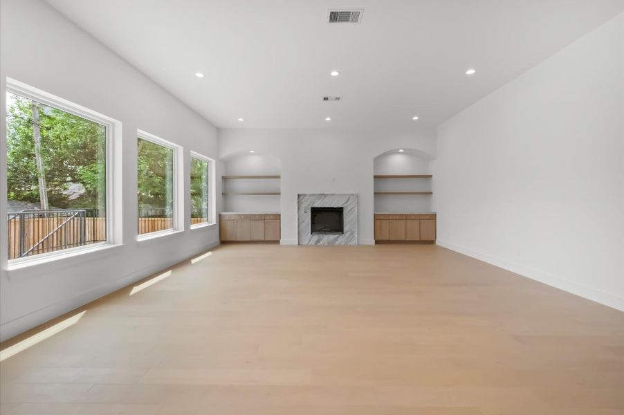 Living room highlighted by 11 foot ceilings and a custom marble chimney. Living room highlighted by 11 foot ceilings and a custom marble chimney.
