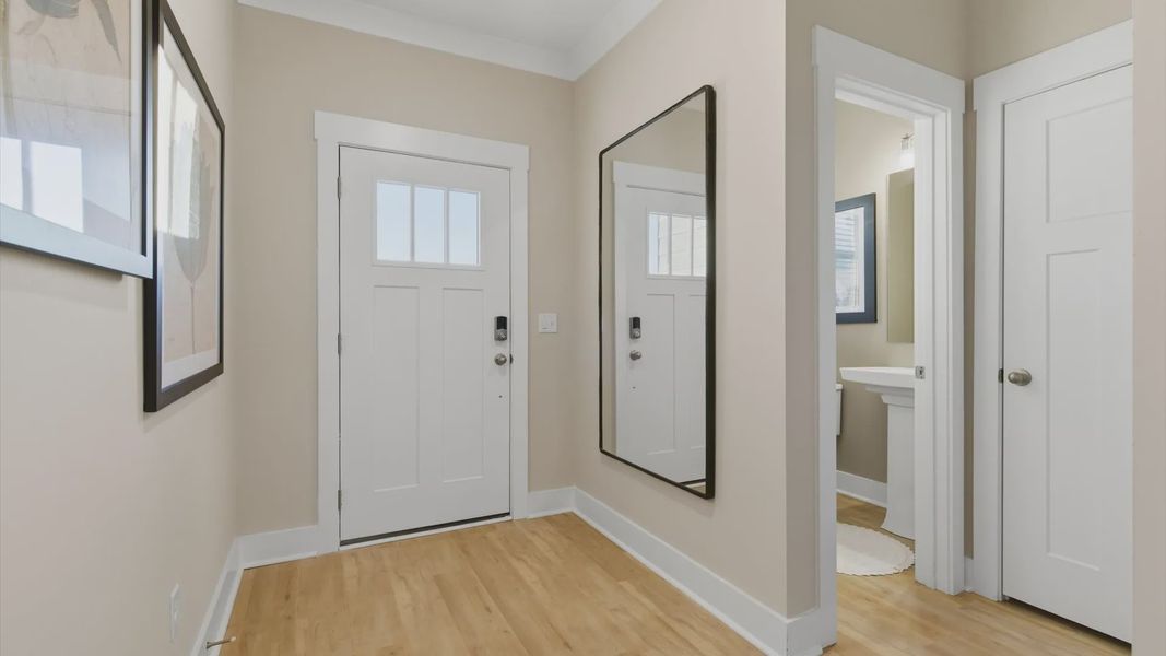 Accomplished hardwood flooring foyer sets the tone for tasteful design throughout the villa at Pelham Crossing