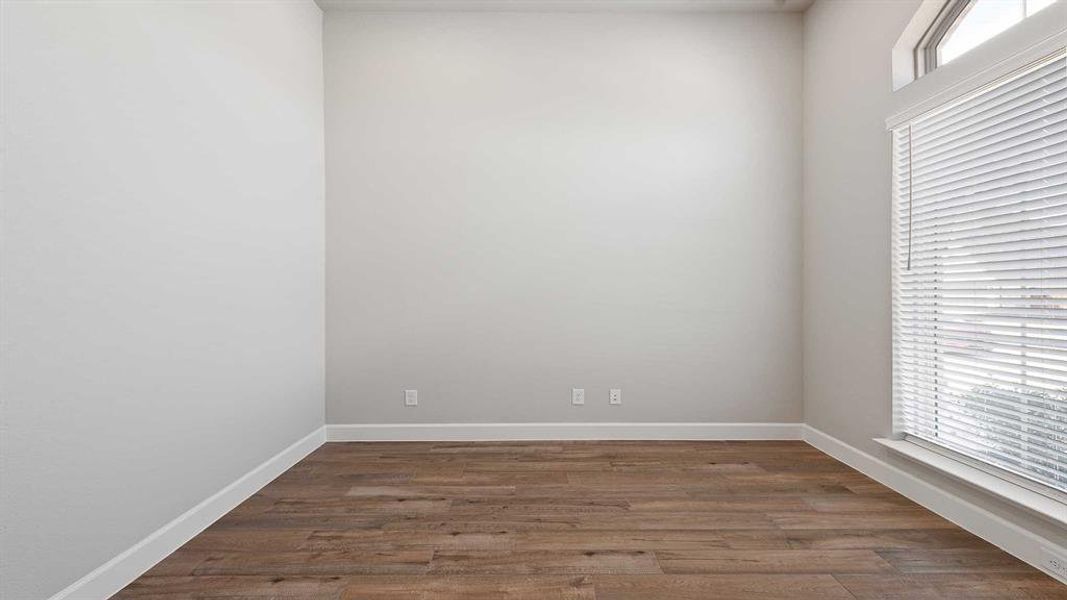 Empty room featuring dark wood-type flooring