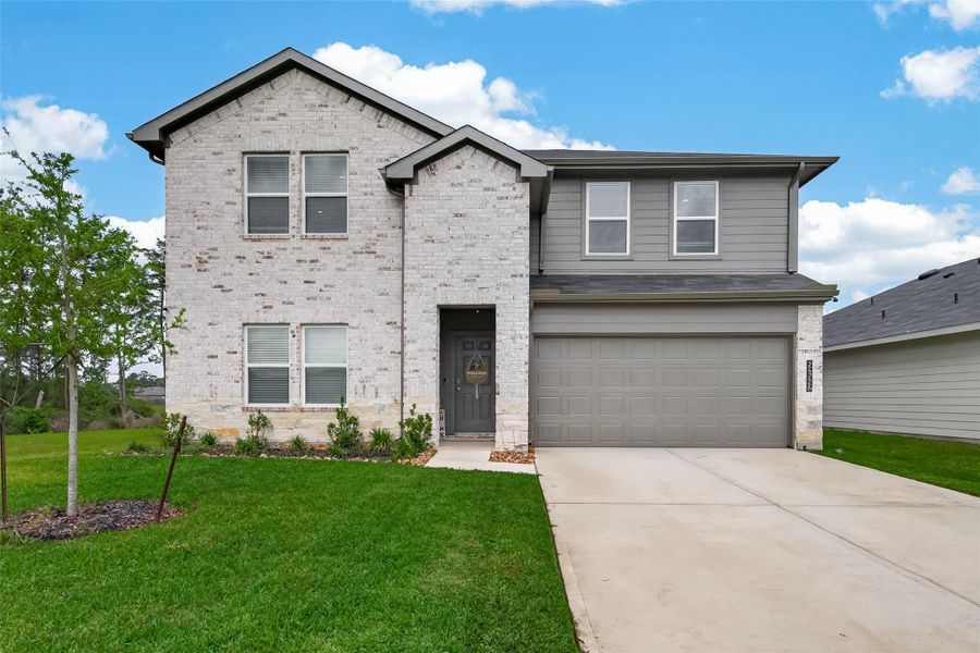 Front exterior of a new home in Grand Pines, Magnolia, TX, highlighting curb appeal (Image 23).