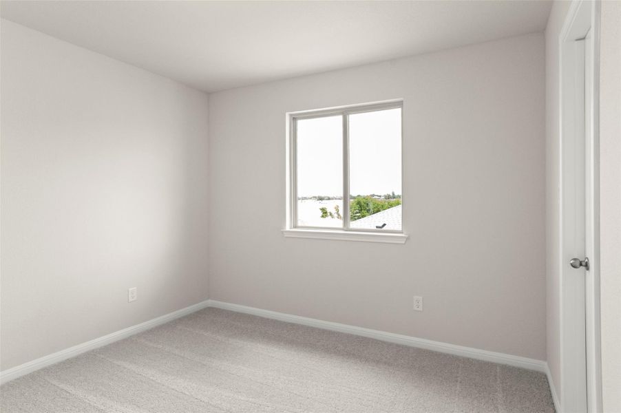 Unfurnished room featuring light carpet and baseboards