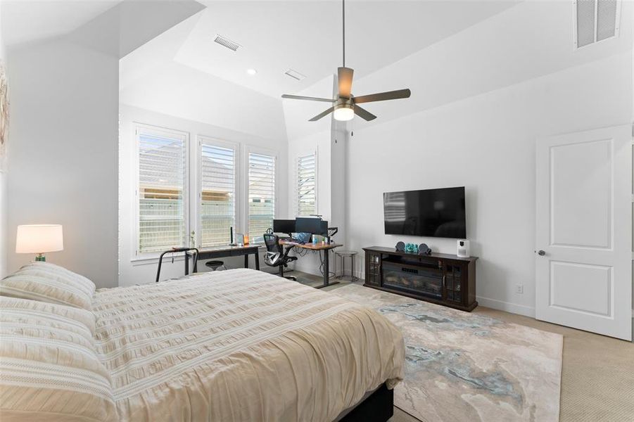 Bedroom with light carpet and a ceiling fan Bedroom with light carpet and a ceiling fan