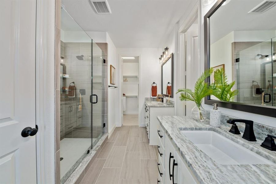 Main bathroom featuring vanity and an enclosed shower