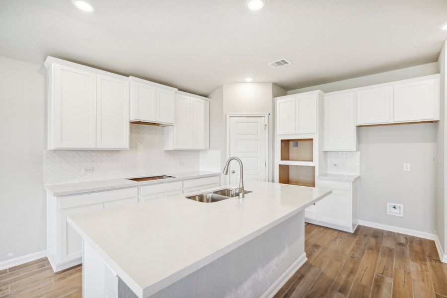 Kitchen in the Fitzhugh floorplan at a Meritage homes community.