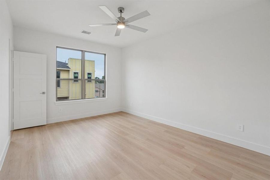 Primary suite with ensuite bathroom and large walk-in closet