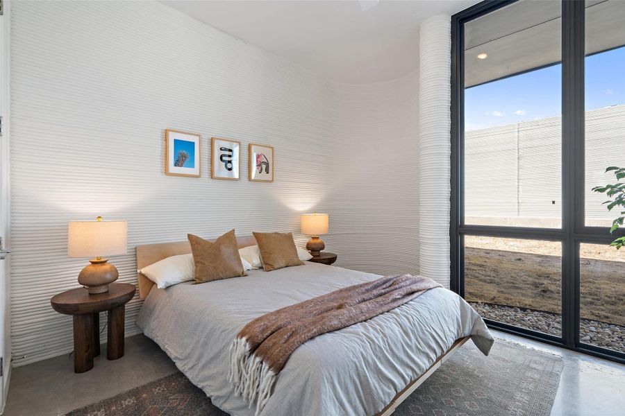 Bedroom with concrete flooring