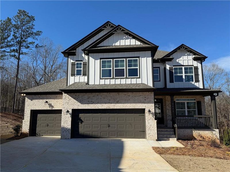 Front exterior of a new home in River Rock, Ball Ground, GA, highlighting curb appeal (Image 25).