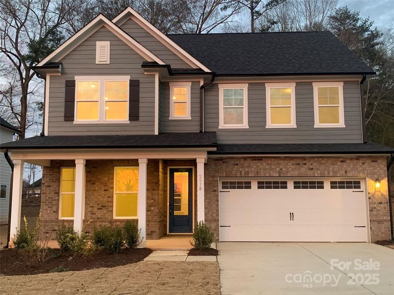Front exterior of a new home in Enclave at Belmont, Belmont, NC, highlighting curb appeal (Image 1). Front exterior of a new home in Enclave at Belmont, Belmont, NC, highlighting curb appeal (Image 1).