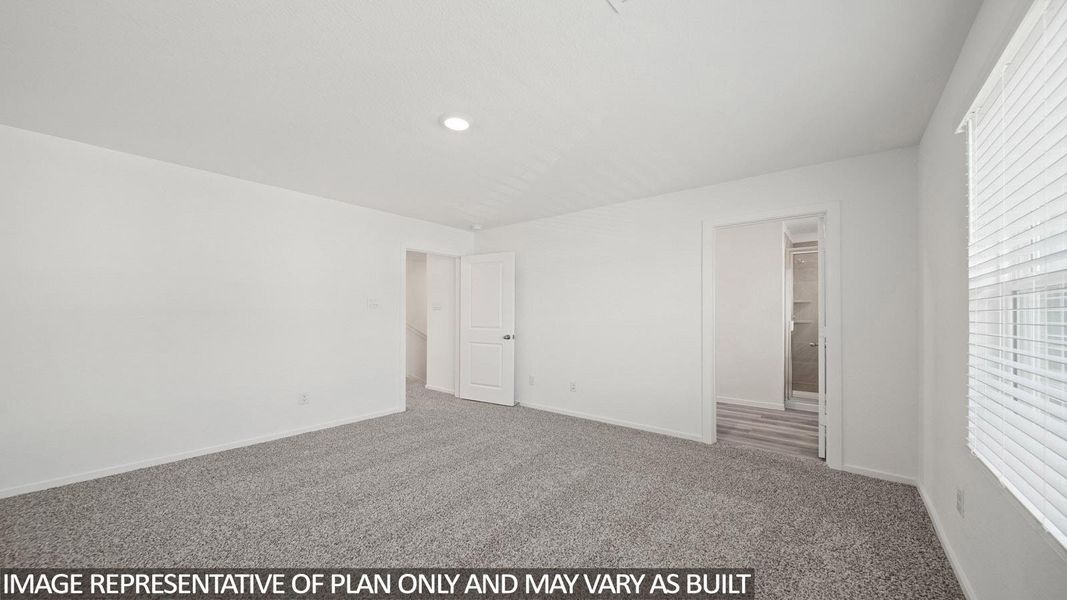 Spacious room featuring neutral carpet flooring, recessed lighting, and white walls