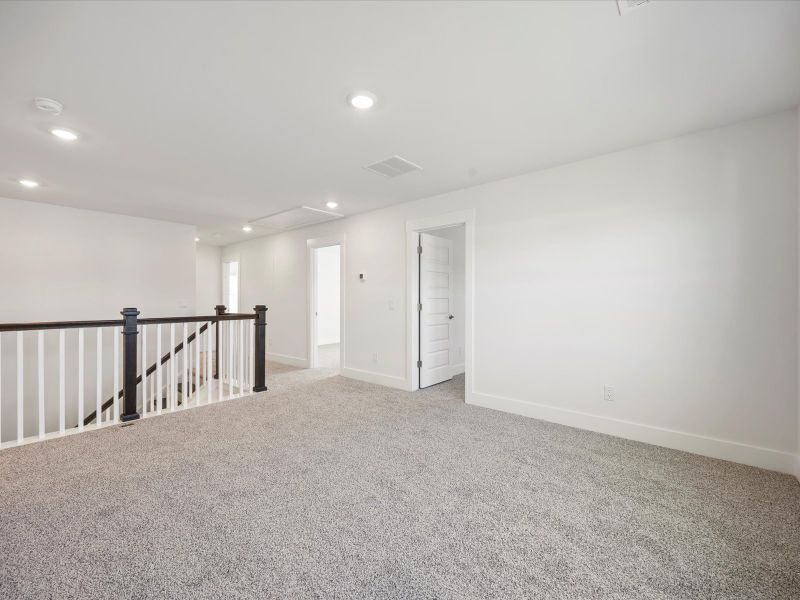 Spacious, unfurnished interior of a new home in The Coves at Lakes of Cane Bay, Summerville (Image 19).