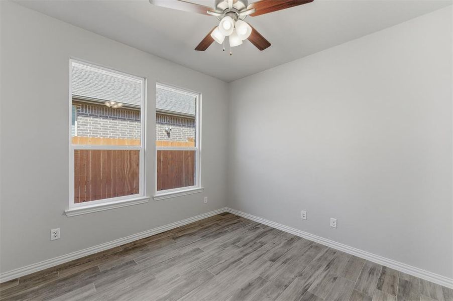 Spare room with ceiling fan and light wood-style flooring