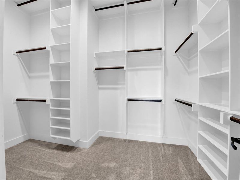 Walk in closet featuring light colored carpet Walk in closet featuring light colored carpet