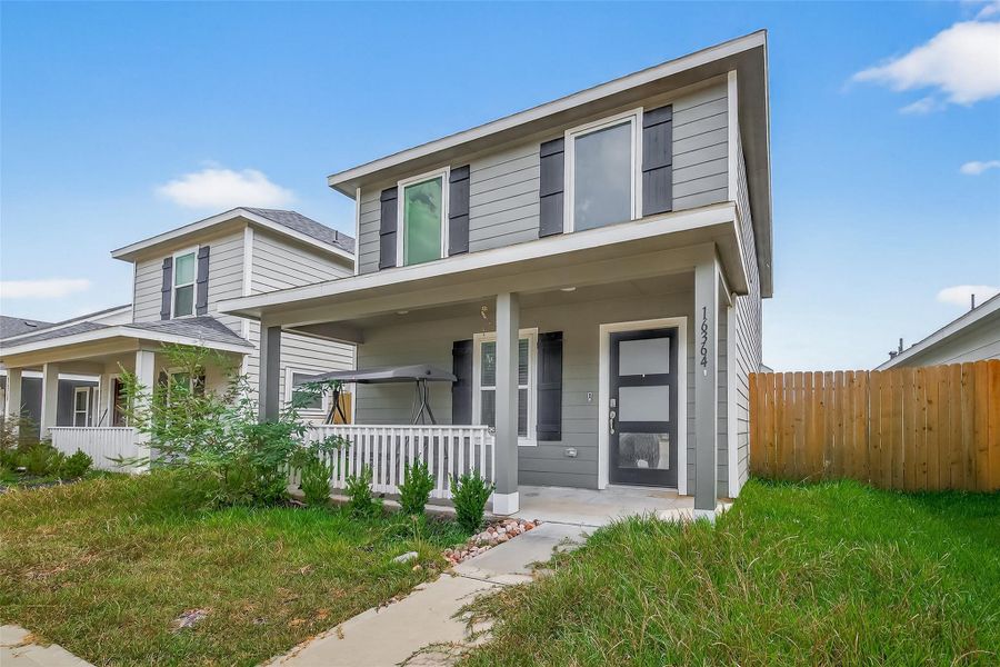 Front exterior of a new home in Marie Village, Conroe, TX, highlighting curb appeal (Image 2). Front exterior of a new home in Marie Village, Conroe, TX, highlighting curb appeal (Image 2).