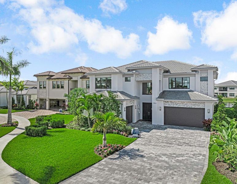 Front exterior of a new home in Apex at Avenir, Palm Beach Gardens, FL, highlighting curb appeal (Image 22).
