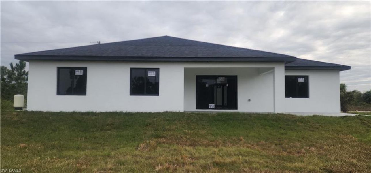 Front exterior of a new home in , Lehigh Acres, FL, highlighting curb appeal (Image 1).
