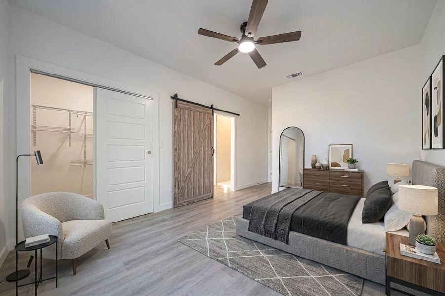 Smooth wood-look flooring and a rustic sliding barn door enhance this modern sleeping space. Smooth wood-look flooring and a rustic sliding barn door enhance this modern sleeping space.
