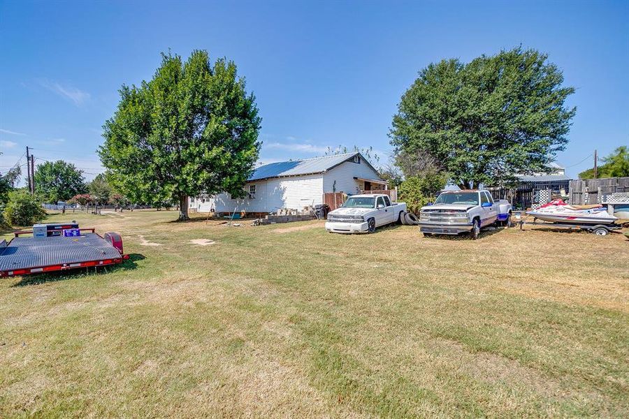 View of grassy yard with a wooden deck View of grassy yard with a wooden deck