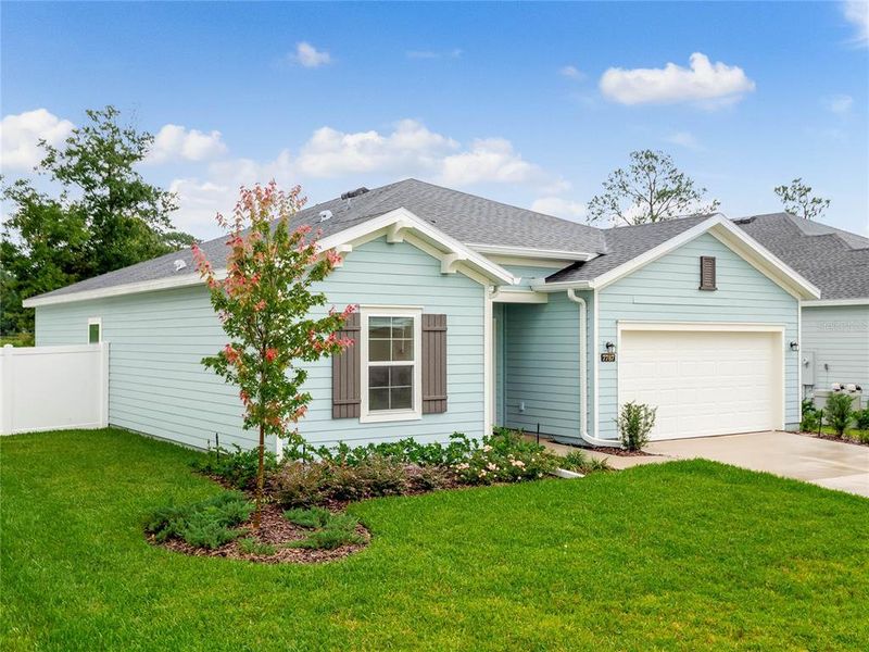 Front exterior of a new home in Liberty Village: Liberty Village - Phase Two, Ocala, FL, highlighting curb appeal (Image 1). Front exterior of a new home in Liberty Village: Liberty Village - Phase Two, Ocala, FL, highlighting curb appeal (Image 1).