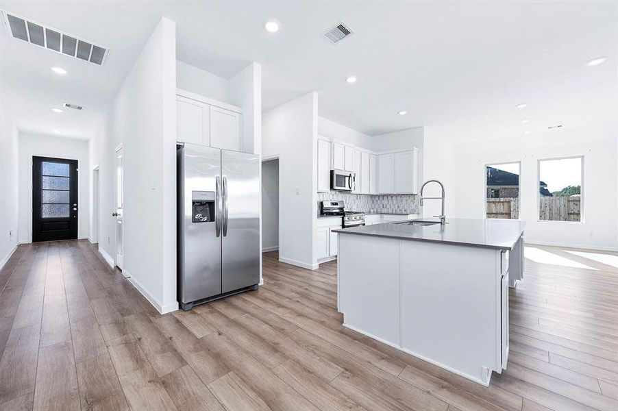 Gather and entertain in style! This open-concept kitchen and living area boasts abundant natural light, modern finishes, and a seamless flow for your family and friends.