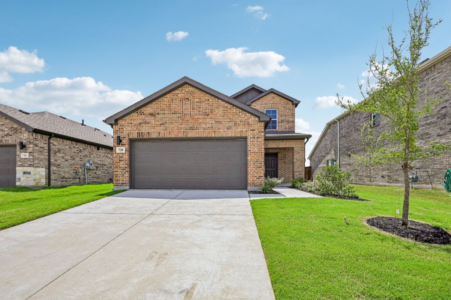 Front exterior of a new home in Overland Grove, Forney, TX, highlighting curb appeal (Image 1). Front exterior of a new home in Overland Grove, Forney, TX, highlighting curb appeal (Image 1).