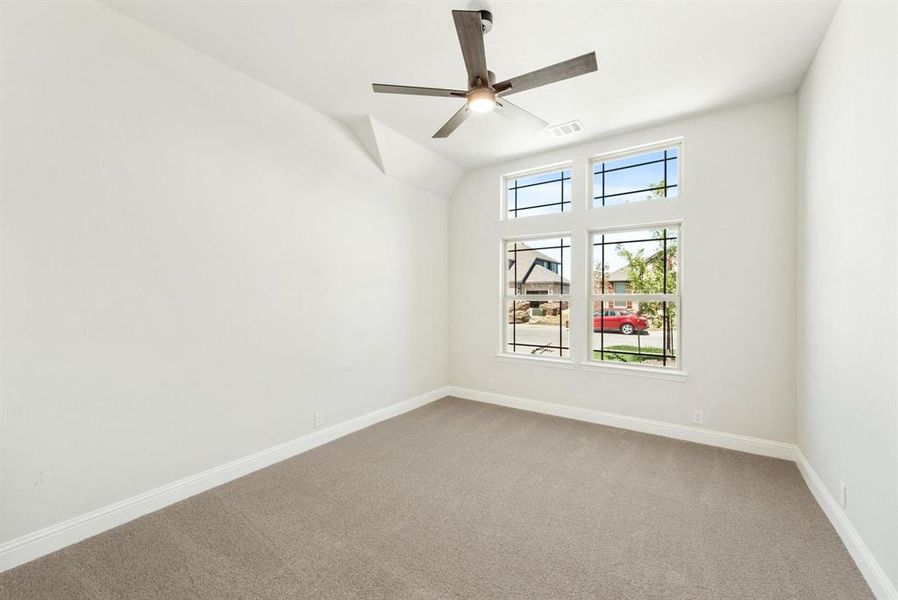 Spacious room featuring neutral carpeting, white baseboards, and light-colored walls Spacious room featuring neutral carpeting, white baseboards, and light-colored walls