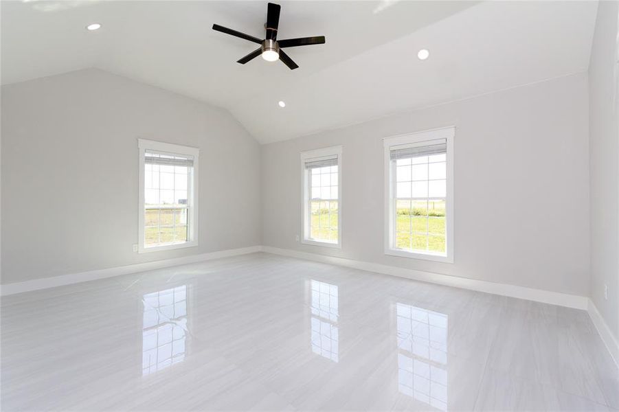 featuring recessed lighting, lofted ceiling, light tile patterned floors, and a ceiling fan