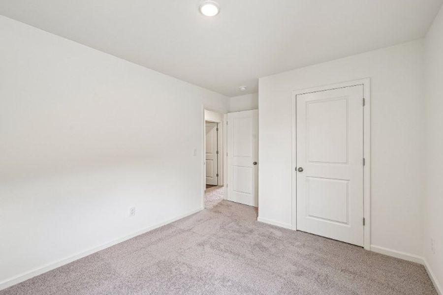A hallway with white doors. A hallway with white doors.