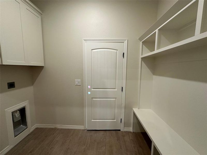 Laundry room with dark wood-style flooring and electric dryer hookup