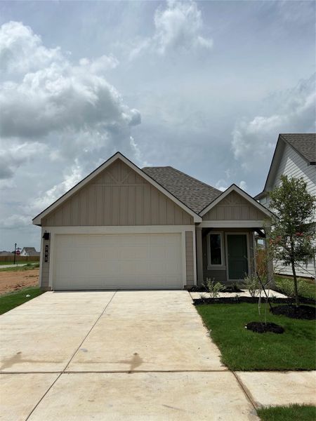 Front exterior of a new home in Cornerstone, Rockdale, TX, highlighting curb appeal (Image 1).